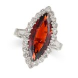 A GARNET AND DIAMOND MARQUISE RING set with a marquise cut garnet in a border of single cut