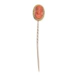 AN ANTIQUE CORAL STICK PIN the head set with a carved coral cameo depicting the bust of a lady