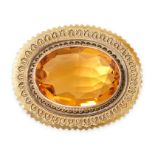 AN ANTIQUE CITRINE BROOCH set with an oval cut citrine within a twisted wirework border, no assay