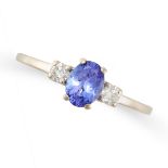 A TANZANITE AND DIAMOND THREE STONE RING in 18ct white gold, set with an oval cut tanzanite
