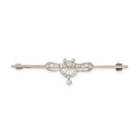 AN ANTIQUE DIAMOND BAR BROOCH set with a central scrolling motif, accented by old and single cut