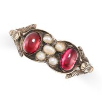 AN ANTIQUE GARNET AND PEARL RING in yellow gold, set with two cabochon garnets and a cluster of seed