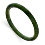 A NEPHRITE JADE BANGLE comprising a single hoop of polished nephrite jade, inner circumference 20.