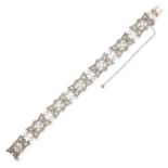 AN ANTIQUE PEARL AND DIAMOND BRACELET comprising seven plaques set with a pearl and rose cut