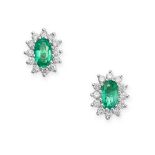 A PAIR OF EMERALD AND DIAMOND CLUSTER EARRINGS in 18ct white gold, each set with an oval cut emerald
