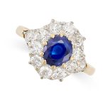 A SAPPHIRE AND DIAMOND CLUSTER RING in 18ct yellow gold, set with an oval cut sapphire of 1.53