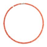 NO RESERVE - A CORAL BEAD NECKLACE comprising a single row of polished coral beads, no assay