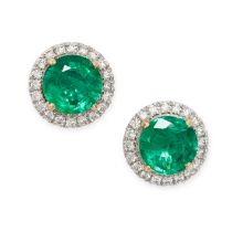 A PAIR OF EMERALD AND DIAMOND CLUSTER EARRINGS each set with a round cut emerald in a border of