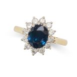 A SAPPHIRE AND DIAMOND CLUSTER RING in 18ct yellow gold, set with an oval cut sapphire of 1.67