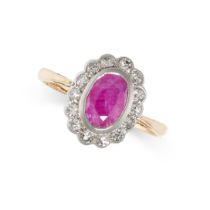 A RUBY AND DIAMOND RING in yellow gold, set with an oval cut ruby in a cluster of single cut