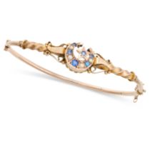 AN AN ANTIQUE VICTORIAN SAPPHIRE AND PEARL BANGLE in yellow gold, comprising a central celestial