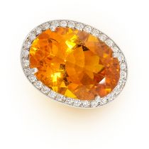 A CITRINE AND DIAMOND RING in 18ct white gold, set with an oval cut citrine of 28.59 carats, in a