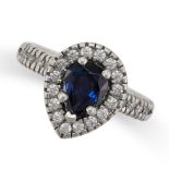 A SAPPHIRE AND DIAMOND RING in platinum, set with a pear cut sapphire in a border of round cut