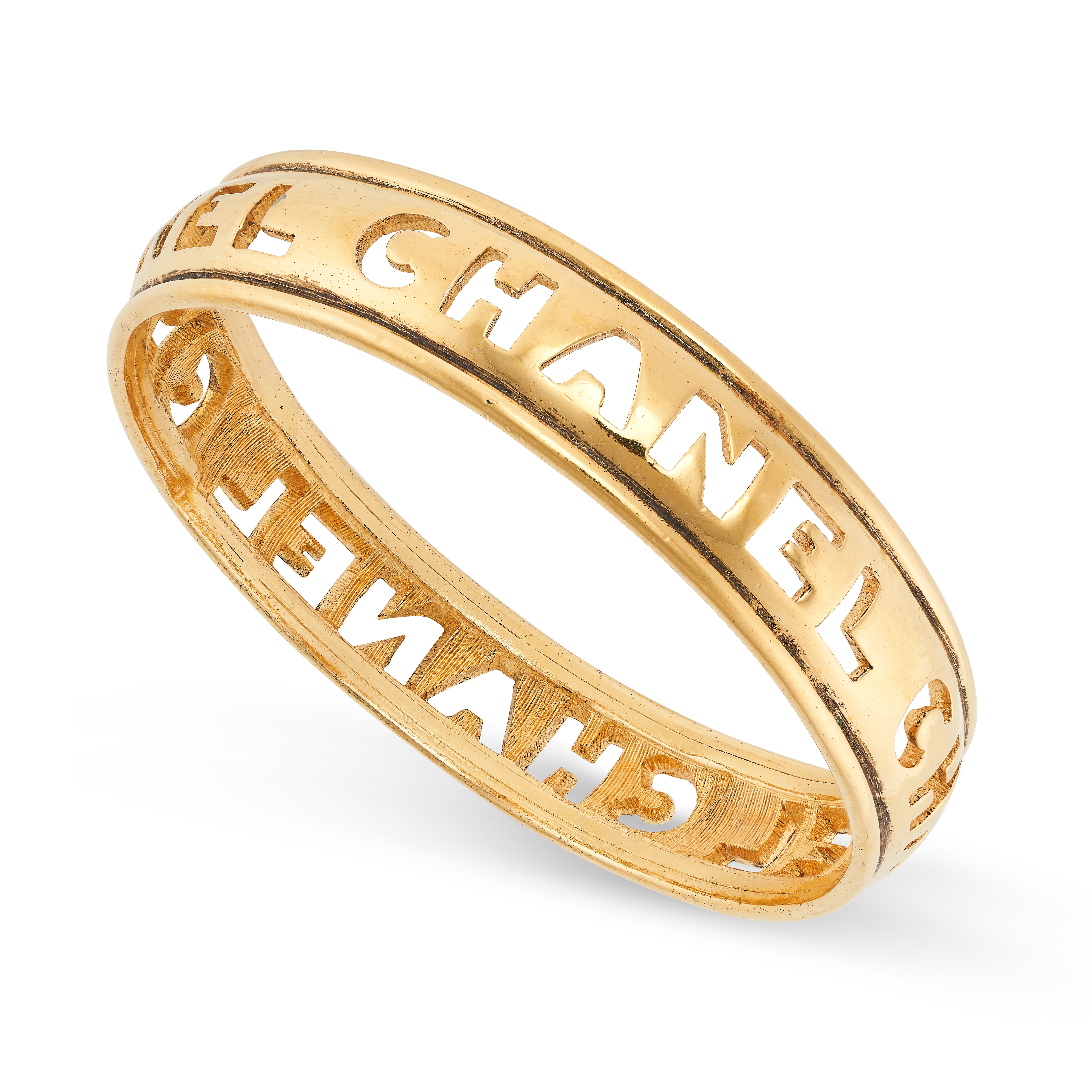 CHANEL, A VINTAGE BANGLE, 1980S featuring CHANEL in cut out design, inner circumference 21.0cm, 42.