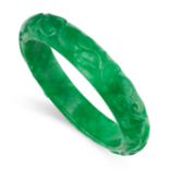 A JADEITE JADE BANGLE the body formed of a single piece of polished jade, carved with scrolling