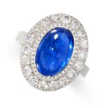 A BURMA NO HEAT SAPPHIRE AND DIAMOND CLUSTER RING in platinum, set with an oval cabochon sapphire of