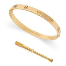 CARTIER, A LOVE BANGLE in 18ct yellow gold, the oval bangle punctuated with screw head motifs,