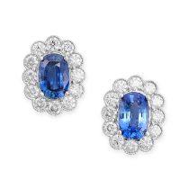 A PAIR OF SAPPHIRE AND DIAMOND CLUSTER EARRINGS in 18ct white gold, each set with an oval cut