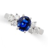 A SAPPHIRE AND DIAMOND RING in platinum, set with an oval cut sapphire of 1.40 carats between