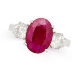 A RUBY AND DIAMOND THREE STONE RING in 18ct white gold, set with an oval cut ruby of 2.41 between