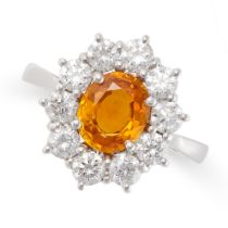 A YELLOW SAPPHIRE AND DIAMOND CLUSTER RING in 18ct white gold, set with an oval cut yellow
