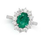 AN EMERALD AND DIAMOND CLUSTER RING in platinum, set with an oval cut emerald of 1.87 carats, in a