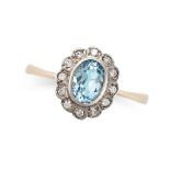 A BLUE TOPAZ AND DIAMOND CLUSTER RING in 9ct yellow gold, set with an oval cut blue topaz in a