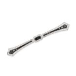 A FRENCH ART DECO ONYX AND DIAMOND BAR BROOCH in platinum, designed as a bar set with step cut