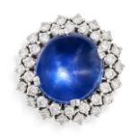 A STAR SAPPHIRE AND DIAMOND CLUSTER RING set with a cabochon star sapphire of 22.0 carats,
