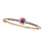 AN ANTIQUE BURMESE RUBY AND DIAMOND BANGLE in yellow gold and silver, set with a cushion cut ruby of