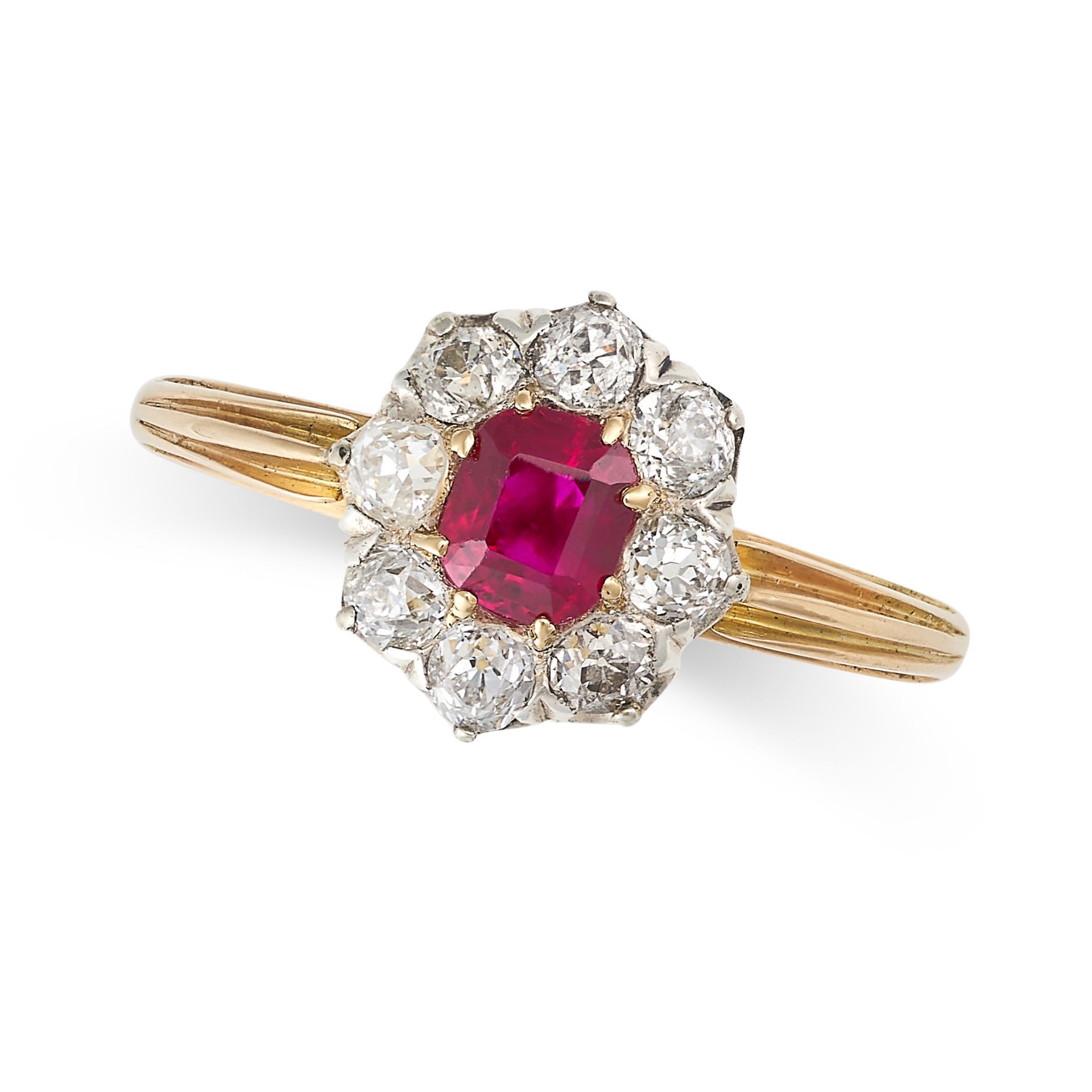 A RUBY AND DIAMOND CLUSTER RING in yellow gold and platinum, set with a step cut ruby of 0.66 carats