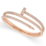 CARTIER, A DIAMOND JUSTE UN CLOU BANGLE in 18ct rose gold, designed as a bent nail pave set with