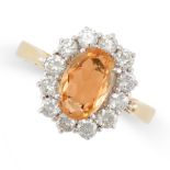 AN IMPERIAL TOPAZ AND DIAMOND CLUSTER RING in 18ct yellow gold, set with an oval cut Imperial