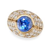 A SAPPHIRE AND DIAMOND BOMBE RING in 18ct yellow gold, set with a round cut sapphire of