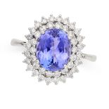 A TANZANITE AND DIAMOND CLUSTER RING in 18ct white gold, set with an oval cut tanzanite of