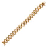 TISHMAN & LIPP, A VINTAGE DIAMOND BRACELET in 18ct yellow gold, in modernist design, the textured