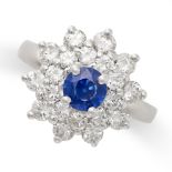 A SAPPHIRE AND DIAMOND CLUSTER RING in platinum, set with a round cut sapphire of 1.41 carats within