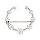 A DIAMOND CRESCENT MOON BROOCH in platinum, set with a row of graduated old European cut diamonds