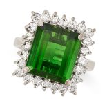 A GREEN TOURMALINE AND DIAMOND CLUSTER RING in 18ct white gold, set with an octagonal step cut green