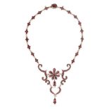 AN ANTIQUE GARNET NECKLACE comprising a series of garnet clusters suspending a scrolling pendant set