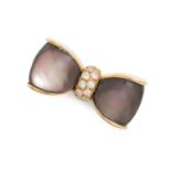 VAN CLEEF & ARPELS, A MOTHER OF PEARL AND DIAMOND BOW BROOCH in 18ct yellow gold, modelled as a