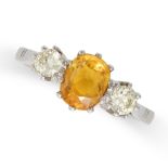 A YELLOW SAPPHIRE AND DIAMOND THREE STONE RING in platinum, set with an oval cut yellow sapphire