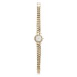 BUECHE GIROD, A LADIES DIAMOND WRISTWATCH in 9ct yellow gold, the circular face set with a border of