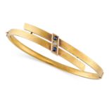 AN ANTIQUE SAPPHIRE AND DIAMOND BANGLE in yellow gold, the hinged body in crossover design, set with