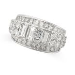 A DIAMOND RING in platinum, set with a row of round brilliant and baguette cut diamonds accented