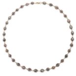 A DIAMOND BEAD NECKLACE comprising a single row of faceted brown diamond beads to yellow gold