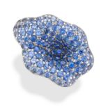 A SAPPHIRE FLOWER RING in 18ct white gold, designed as a flower head, set throughout with round