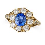 A SAPPHIRE AND DIAMOND CLUSTER RING in 18ct yellow gold, set with an oval cut sapphire of