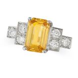 A YELLOW SAPPHIRE AND DIAMOND RING in platinum, set with an octagonal cut yellow sapphire of