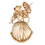 A VINTAGE RUBY BROOCH in 18ct yellow gold, designed as a lady holding a parasol, set with a round